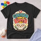 Chosen Since Birth Christian kids shirt in black featuring a smiling lamb surrounded by flowers
