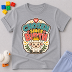 Chosen Since Birth Christian kids shirt in gray featuring a smiling lamb surrounded by flowers
