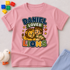 Daniel Loved Lions Christian kids shirt in pink featuring Daniel with smiling lions
