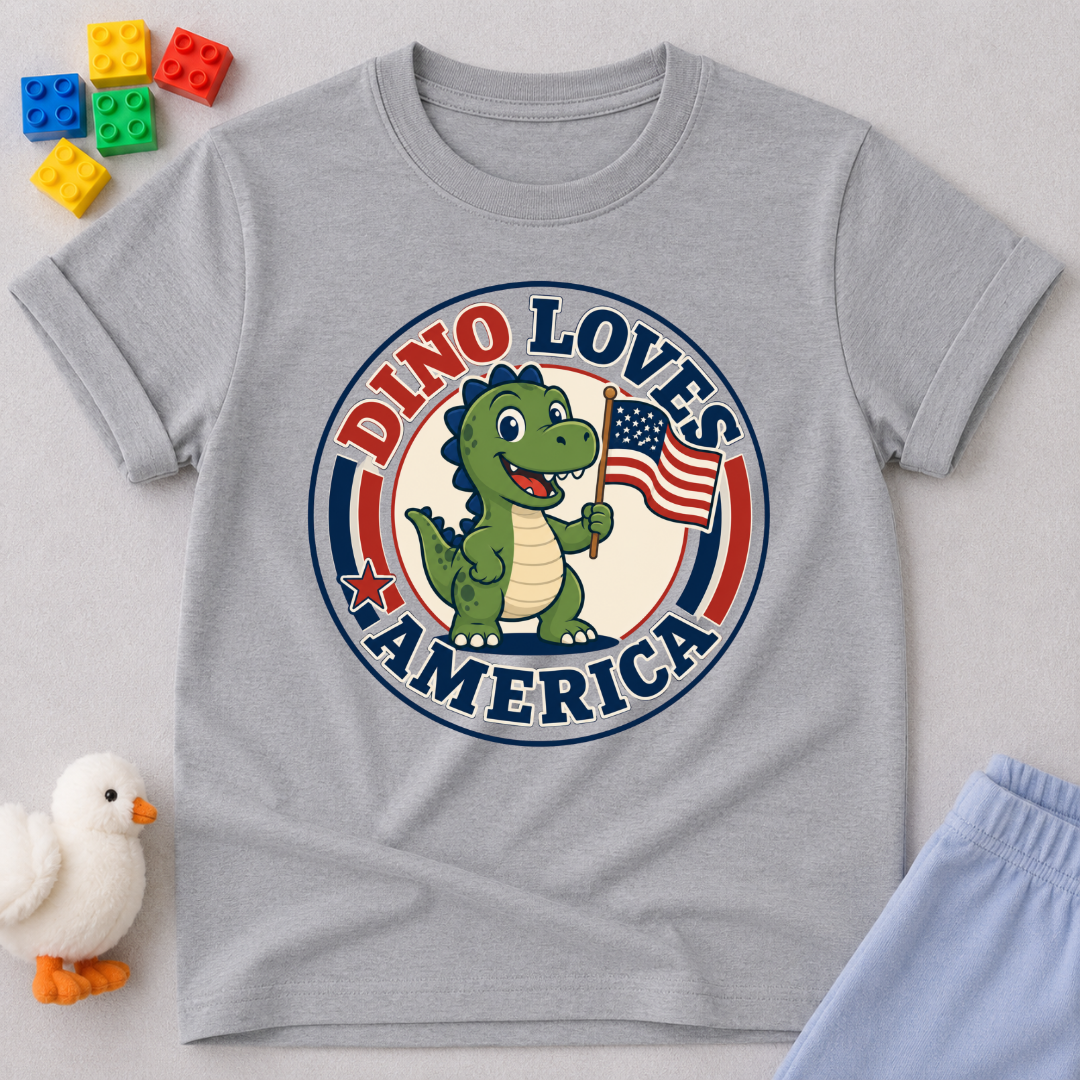 Dino Loves America Shirt Christian kids shirt in gray featuring a dinosaur holding an American flag
