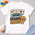Grace Before Graham Crackers Christian kids shirt in white featuring a smiling graham cracker
