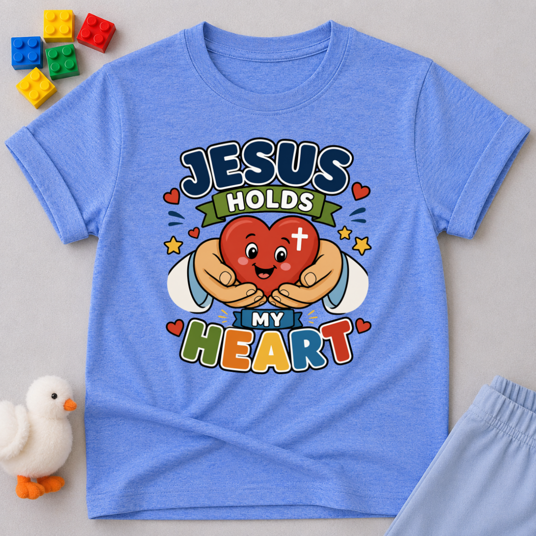 Jesus Holds My Heart Christian kids shirt in blue featuring a smiling heart with faith-inspired typography
