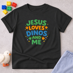 Jesus Loves Dinos And Me Christian kids shirt in Black featuring colorful dinosaur themed typography