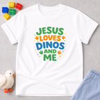 Jesus Loves Dinos And Me Christian kids shirt in White featuring colorful dinosaur themed typography