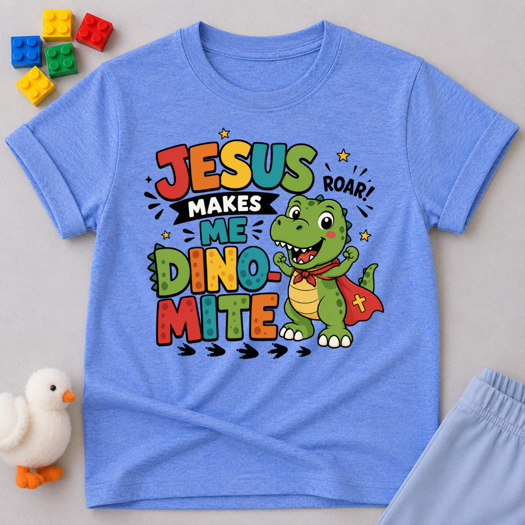 Jesus Makes Me Dino-Mite Christian kids shirt in blue featuring a smiling dinosaur with a cape
