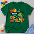 Jesus Makes Me Dino-Mite Christian kids shirt in green featuring a smiling dinosaur with a cape
