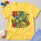 Jesus Makes Me Dino-Mite Christian kids shirt in yellow featuring a smiling dinosaur with a cape
