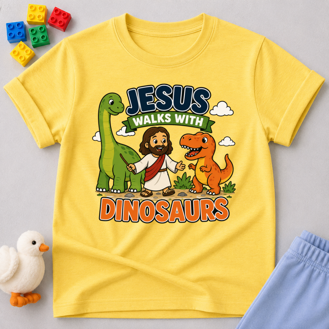 Jesus Walks with Dinosaurs Christian kids shirt in yellow featuring Jesus walking alongside friendly dinosaurs
