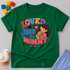 Loved by Jesus & Mommy Christian kids shirt in green featuring a mother hugging her child with a faith-filled design
