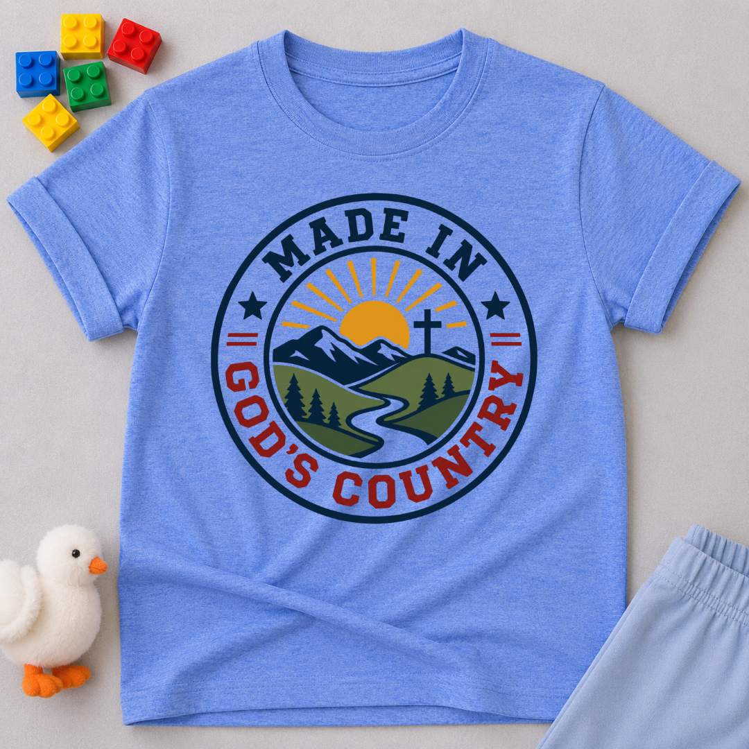 Made in God's Country Shirt Christian kids shirt in blue featuring mountains, a cross, and patriotic artwork
