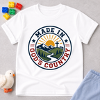 Made in God's Country Shirt Christian kids shirt in white featuring mountains, a cross, and patriotic artwork
