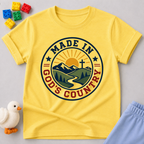 Made in God's Country Shirt Christian kids shirt in yellow featuring mountains, a cross, and patriotic artwork
