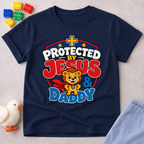 Protected by Jesus & Daddy Christian kids shirt in navy featuring a brave lion inside a protective shield
