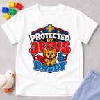 Protected by Jesus & Daddy Christian kids shirt in white featuring a brave lion inside a protective shield
