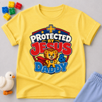 Protected by Jesus & Daddy Christian kids shirt in yellow featuring a brave lion inside a protective shield
