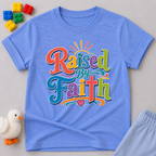 Raised by Faith Typography Christian kids shirt in blue featuring colorful faith-inspired lettering
