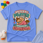 Raised by Prayer Spoiled by Grandma Christian kids shirt in blue featuring a grandmother hugging a child