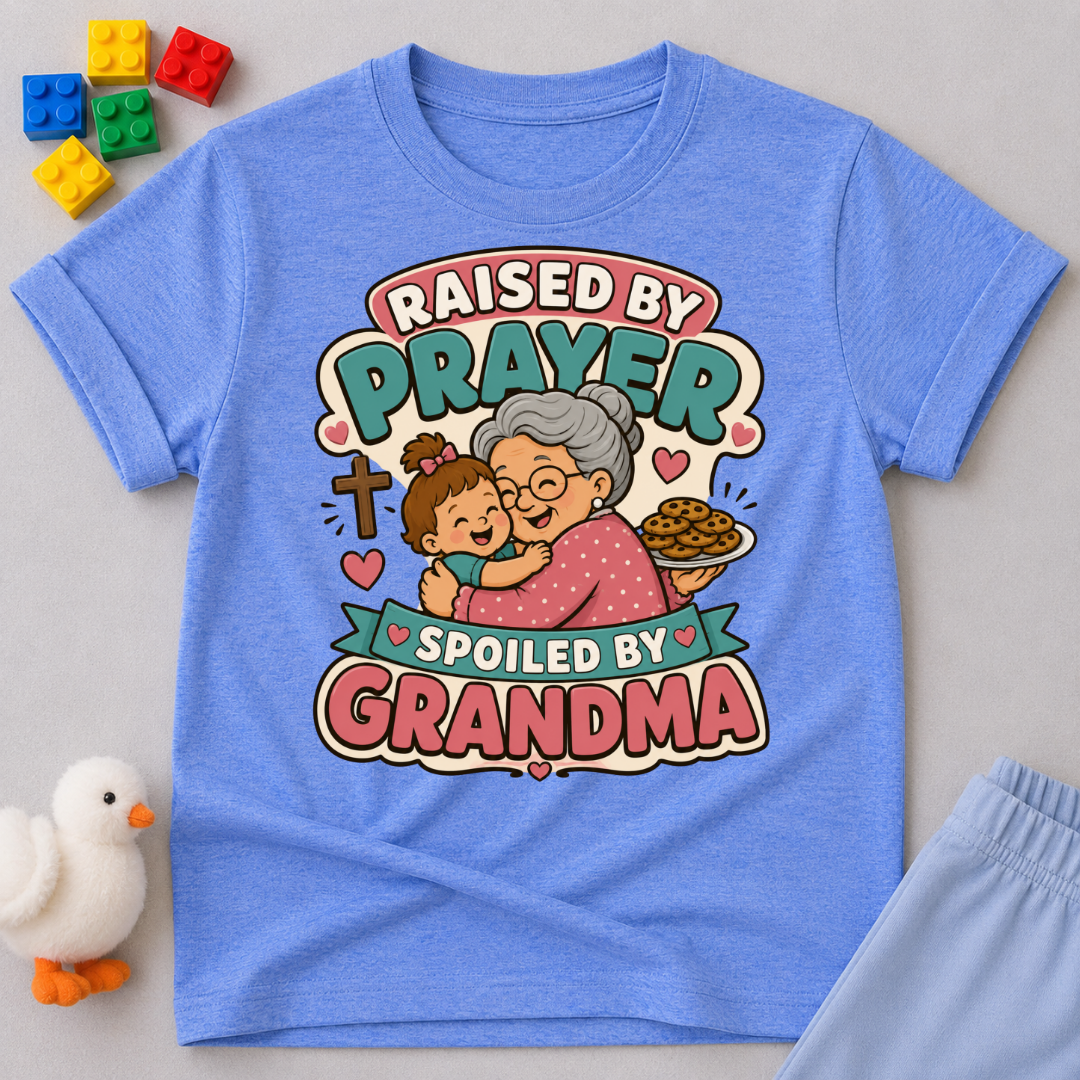 Raised by Prayer Spoiled by Grandma Christian kids shirt in blue featuring a grandmother hugging a child