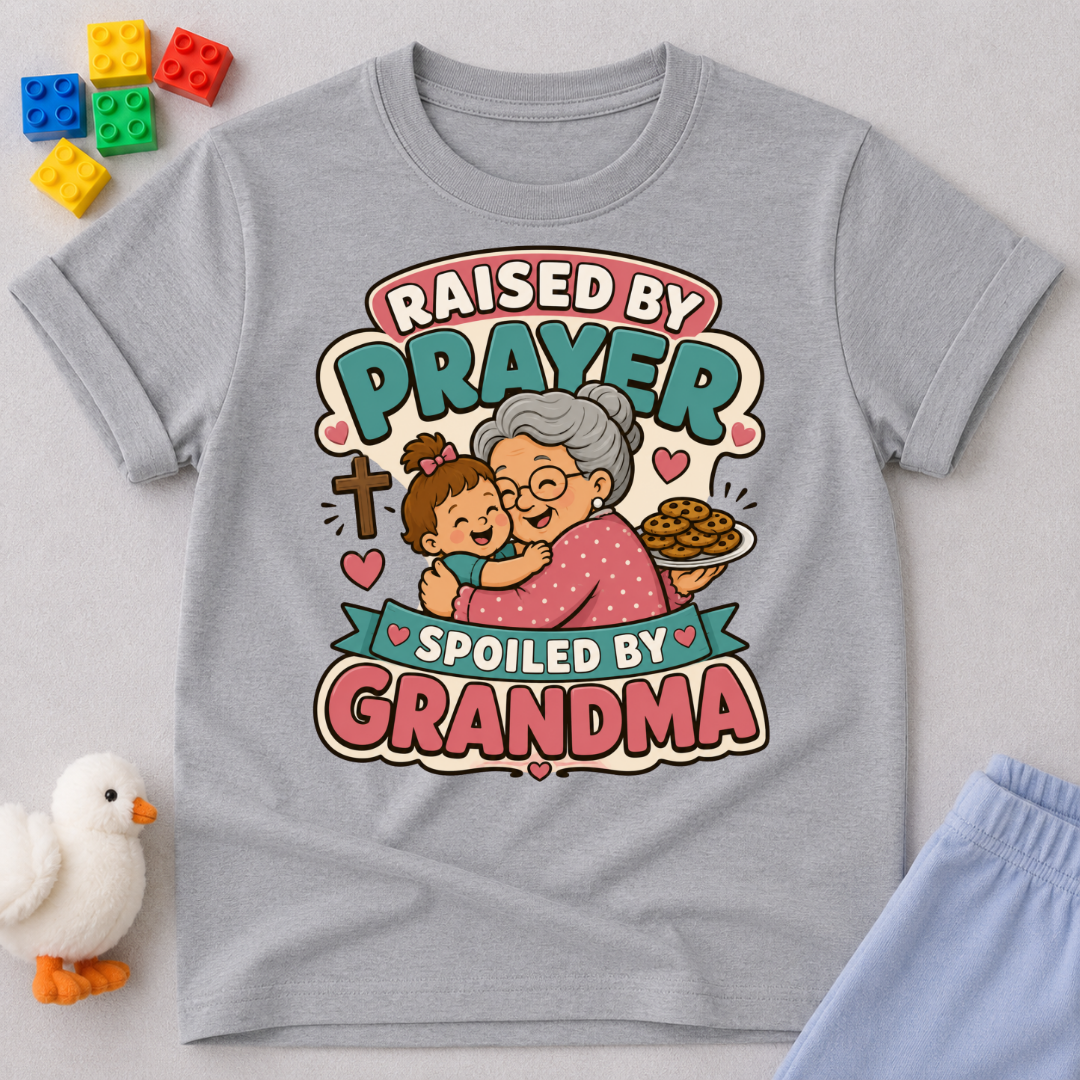 Raised by Prayer Spoiled by Grandma Christian kids shirt in gray featuring a grandmother hugging a child
