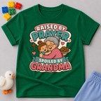 Raised by Prayer Spoiled by Grandma Christian kids shirt in green featuring a grandmother hugging a child
