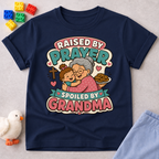 Raised by Prayer Spoiled by Grandma Christian kids shirt in navy featuring a grandmother hugging a child
