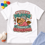 Raised by Prayer Spoiled by Grandma Christian kids shirt in white featuring a grandmother hugging a child
