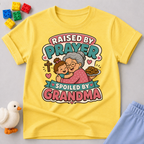 Raised by Prayer Spoiled by Grandma Christian kids shirt in yellow featuring a grandmother hugging a child
