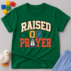 Raised on Prayer Christian kids shirt in green featuring bold typography and praying hands
