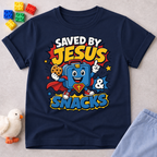 Saved by Jesus and Snacks Christian kids shirt in navy featuring a smiling superhero snack character
