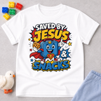 Saved by Jesus and Snacks Christian kids shirt in white featuring a smiling superhero snack character
