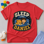 Sleep Like Daniel Christian kids shirt in red featuring a sleeping child and lion under the stars
