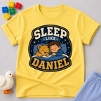 Sleep Like Daniel Christian kids shirt in yellow featuring a sleeping child and lion under the stars
