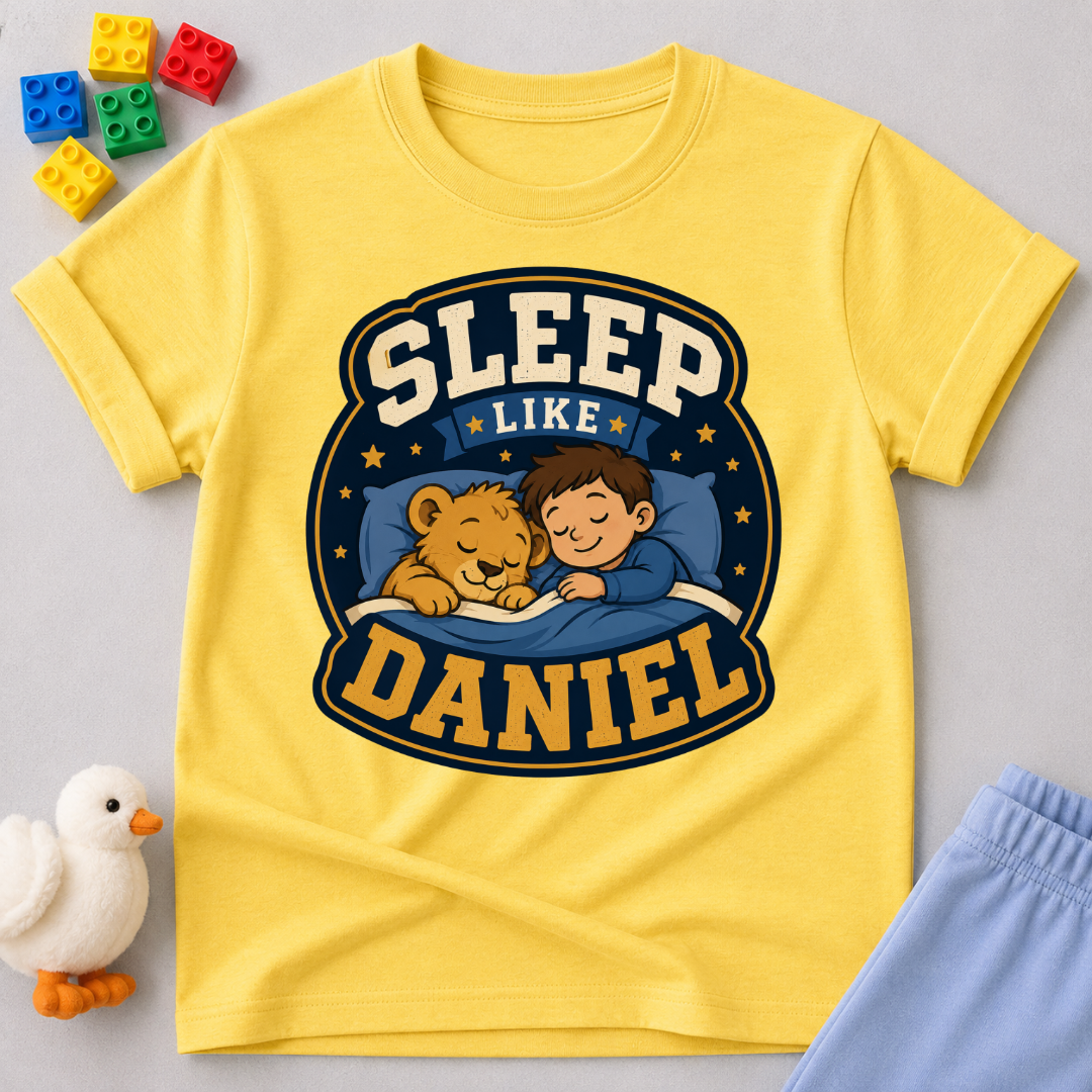 Sleep Like Daniel Christian kids shirt in yellow featuring a sleeping child and lion under the stars
