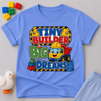 Tiny Builder Big Dreams Christian kids shirt in blue featuring a cheerful construction vehicle
