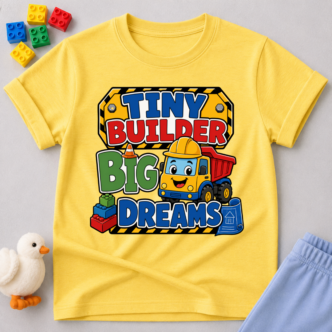 Tiny Builder Big Dreams Christian kids shirt in yellow featuring a cheerful construction vehicle
